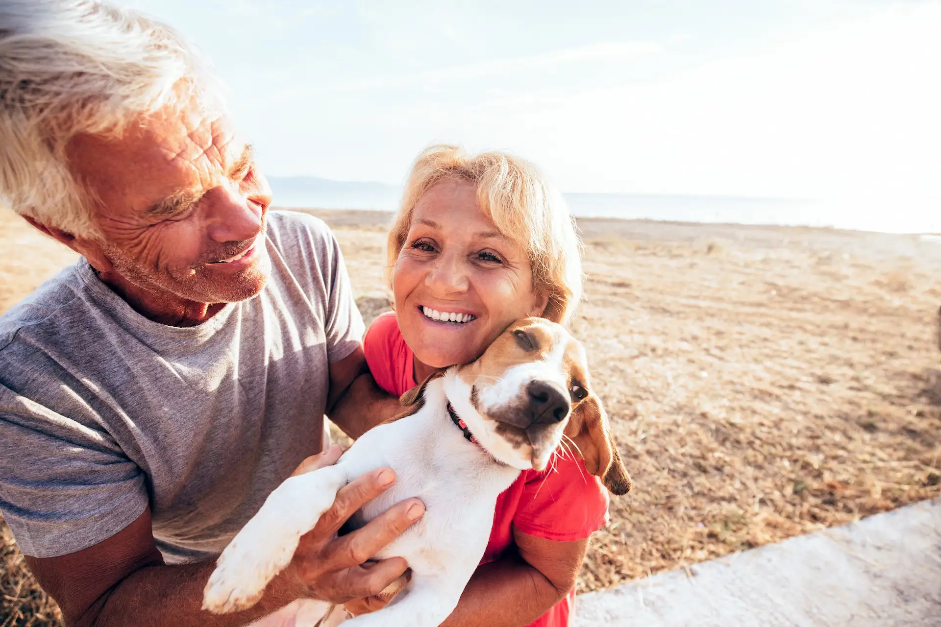 Frau guckt mit Hund auf einen See