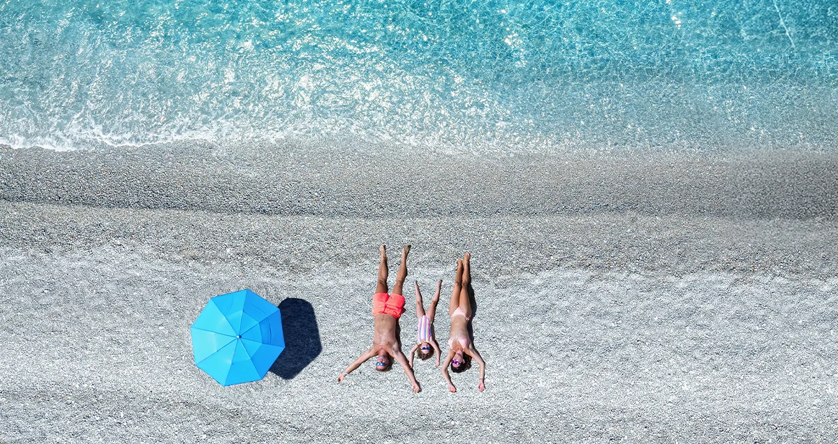 Family is laying at the beach during their holiday