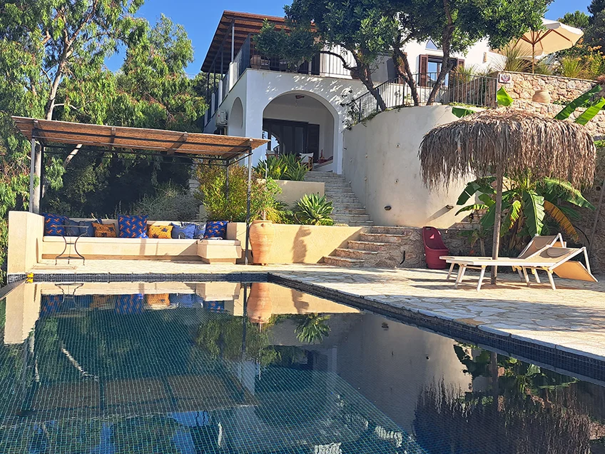 Villa with pool and sun chairs